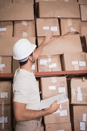 Warehouse worker with clipboard