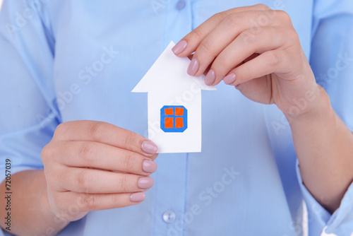 Woman hands holding paper house close up