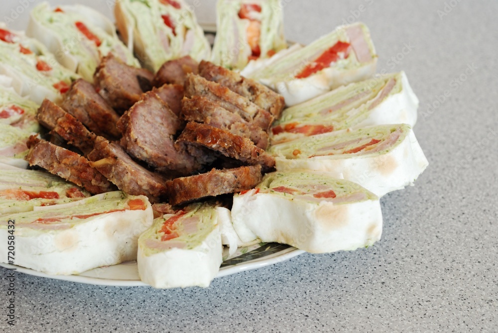 pita stuffed with fish and meat in a white plate