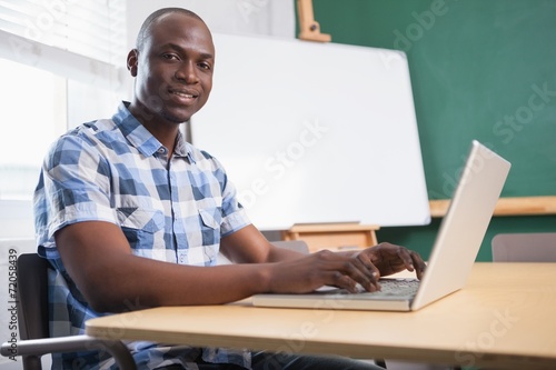 Cheerful creative businessman working on computer