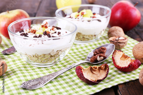 Oatmeal in bowls, yogurt, apples and walnuts