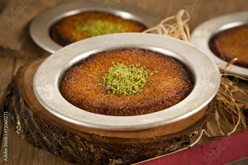 Turkish dessert kunefe with pistachio powder photo