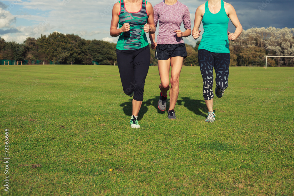 Fototapeta premium Three women running in the park