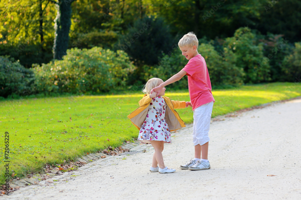 Brother and sister playing in the park Brother and sister playing in the park