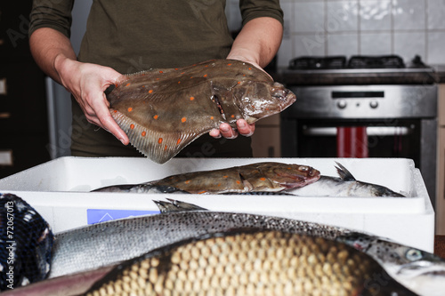 Woman holding a plaice and other fish