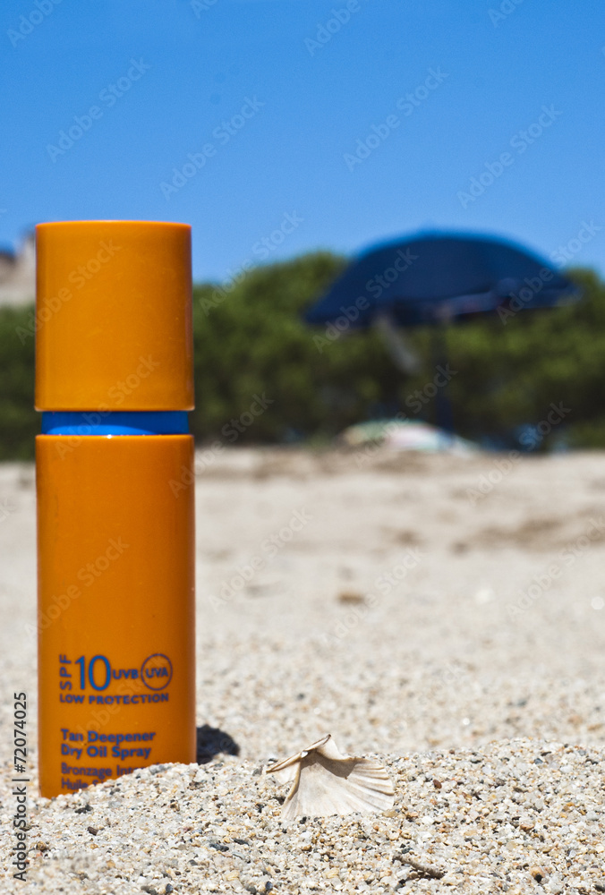 sunscreen cream on beach,seashell, trees, umbrellas and blue sky sunscreen cream on beach,seashell, trees, umbrellas and blue sky