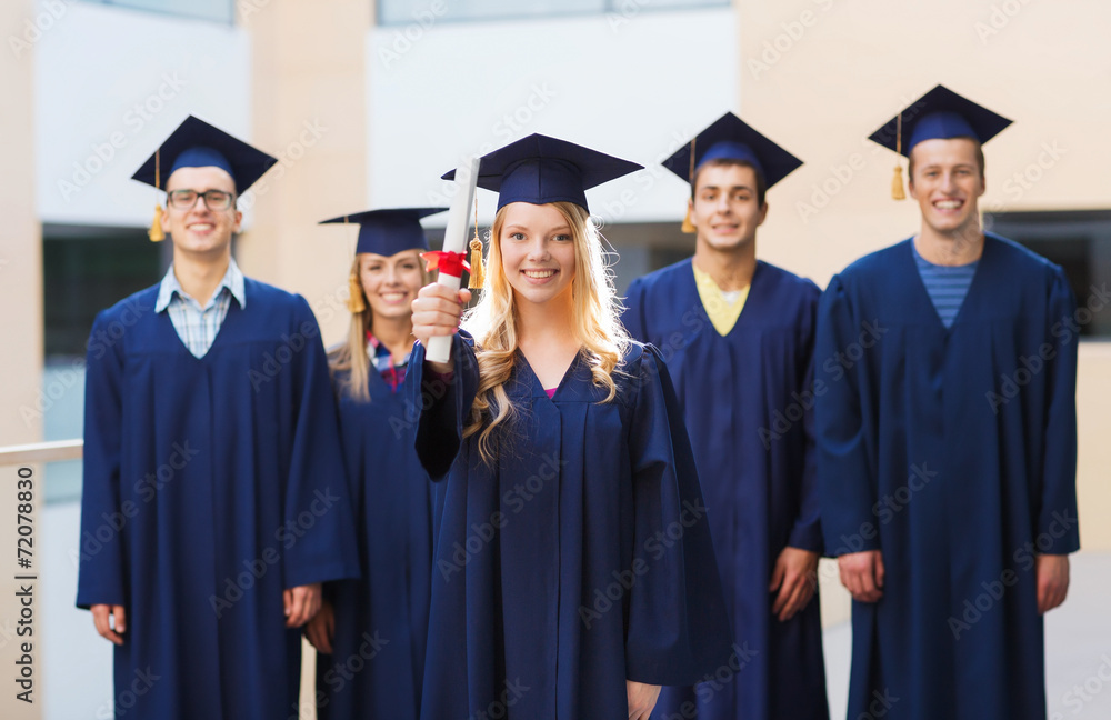 group of smiling students in mortarboards group of smiling students in mortarboards