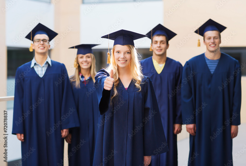 group of smiling students in mortarboards