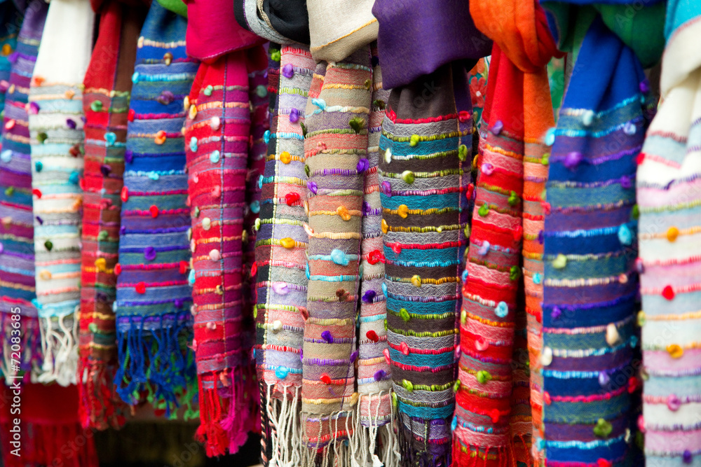 selection of scarves at a market stall