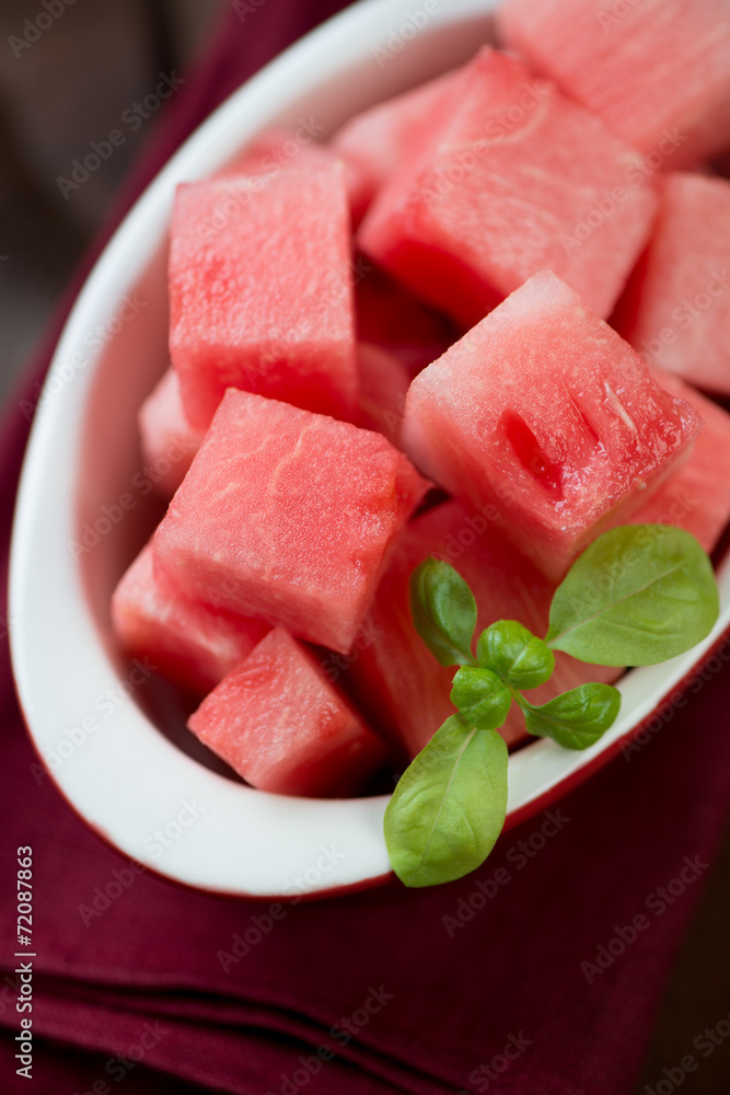 Close-up of a glass bowl with watermelon cubes, vertical shot Close-up of a glass bowl with watermelon cubes, vertical shot