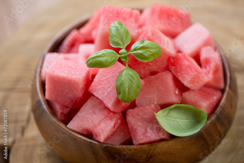 Watermelon cubes in a wooden bowl, close-up, horizontal shot