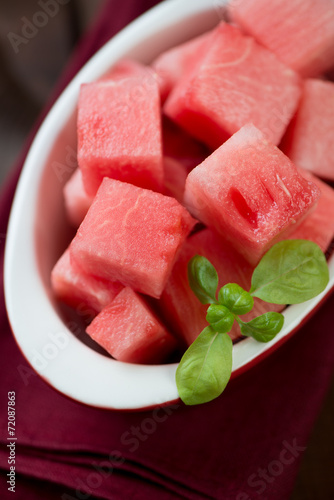 Close-up of a glass bowl with watermelon cubes, vertical shot