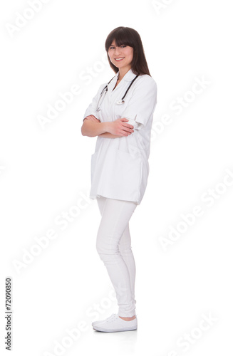 Portrait Of Smiling Female Doctor Standing Arms Crossed