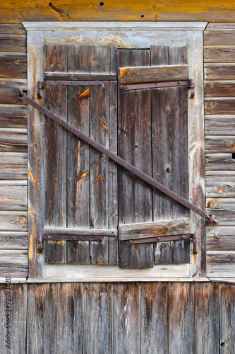 Closed window in a wooden house