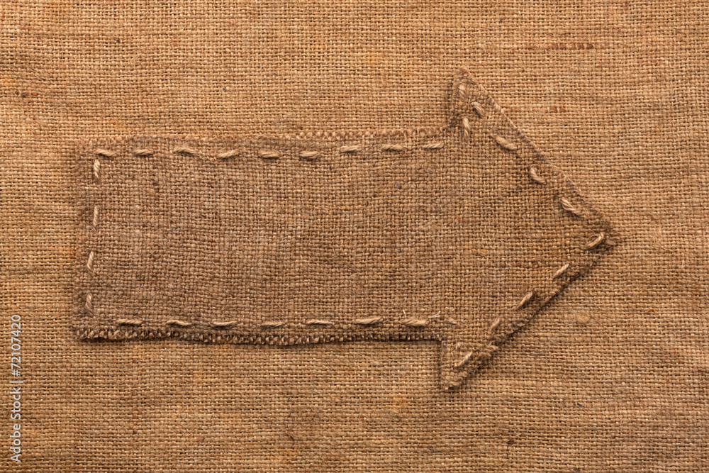 Arrow of burlap lies on a sacking background Arrow of burlap lies on a sacking background