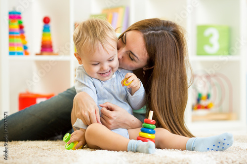 happy mother and child son playing indoor at home