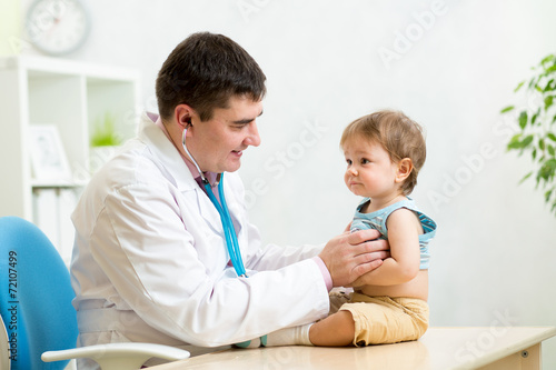 pediatrician man examining heartbeat of baby boy with