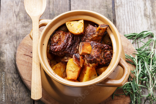 meat and potatoes baked in a pot