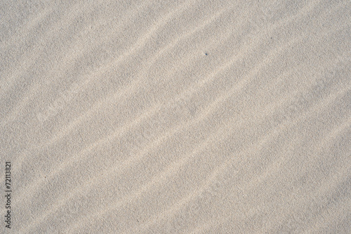 A background texture of unrefined, damp and grainy natural golde