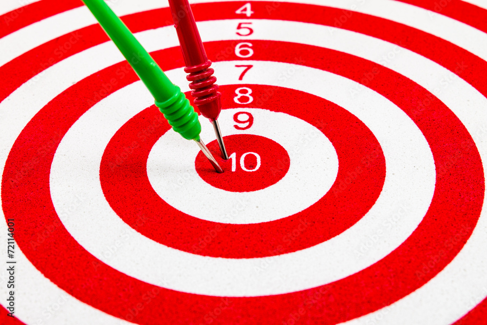 Red dart target with red and green arrows Close up Red dart target with red and green arrows Close up