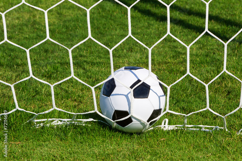 Soccer football in Goal net field. 