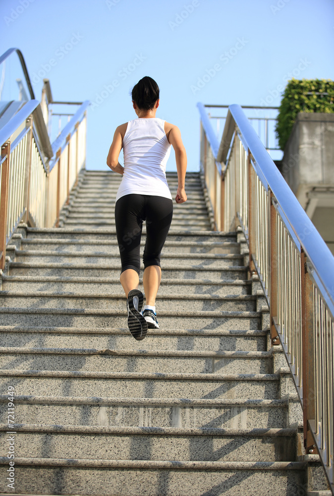 young fitness woman running up on stairs young fitness woman running up on stairs