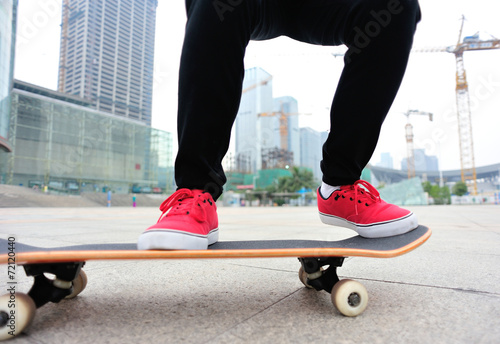 woman skateboarder legs skateboarding at city © lzf