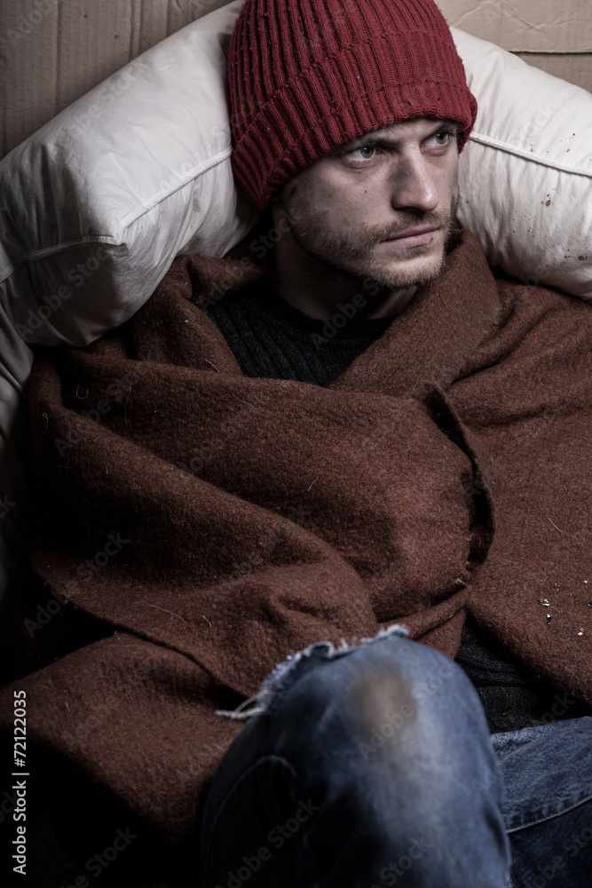 Homeless man covers himself with a blanket Homeless man covers himself with a blanket