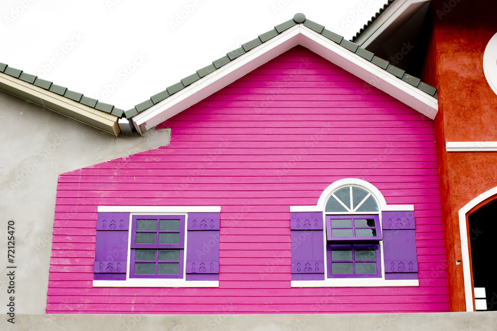 Colorful house, pink and violet color of wood house.