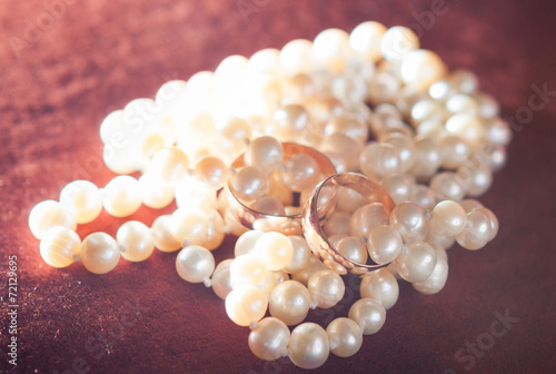 wedding rings on pearl necklace