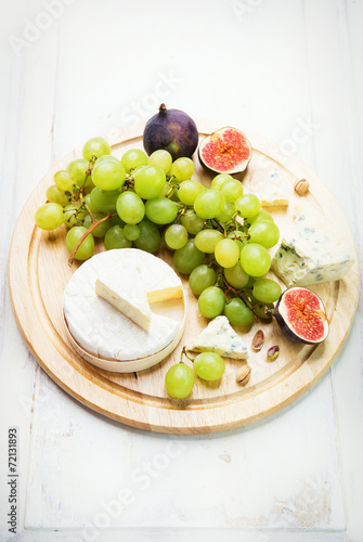 various types of cheese with grapes and figs
