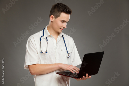 Male doctor using a laptop