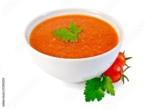 Soup tomato in white bowl with parsley and tomatoes