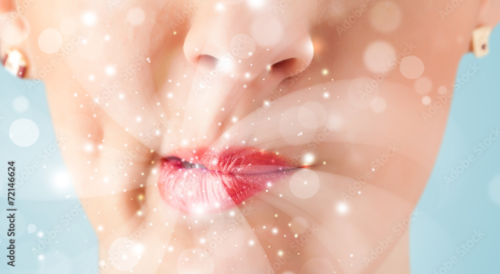 Pretty woman lips blowing abstract white lights Pretty woman lips blowing abstract white lights