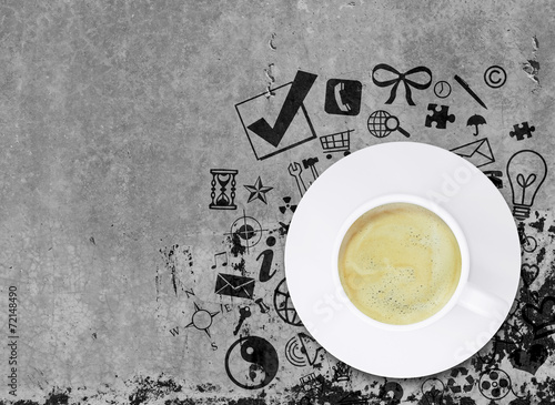 Coffee cup on concrete floor with various social icons