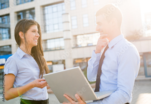 Wallpaper Mural Young Business Partners With A Laptop Torontodigital.ca