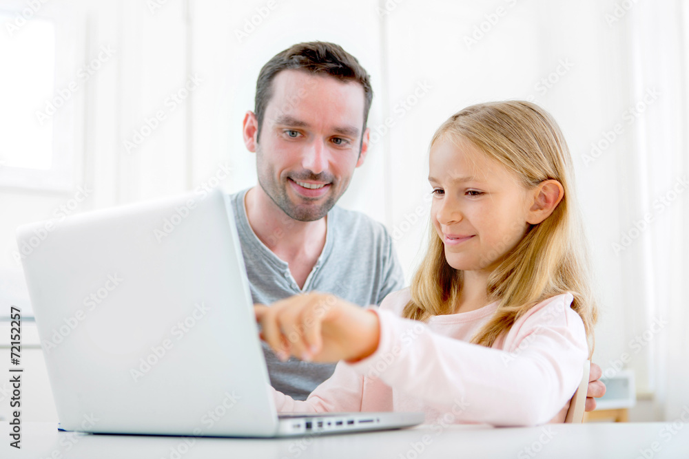 Father and his blond daughter using laptop Father and his blond daughter using laptop