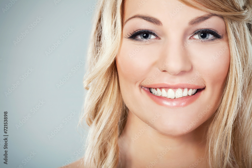 Close-up of a beautiful caucasian blond woman smiling Close-up of a beautiful caucasian blond woman smiling