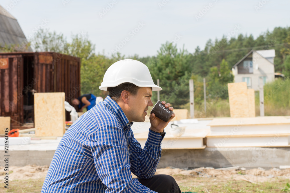 Building contractor taking a coffee break