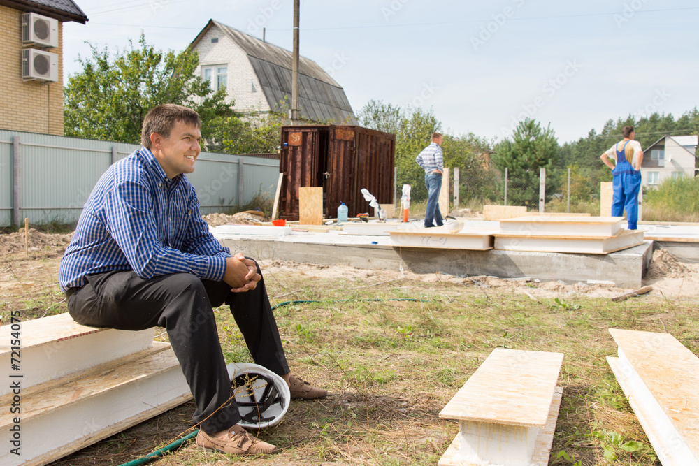 Smiling Site Engineer Sitting on White Platforms Smiling Site Engineer Sitting on White Platforms