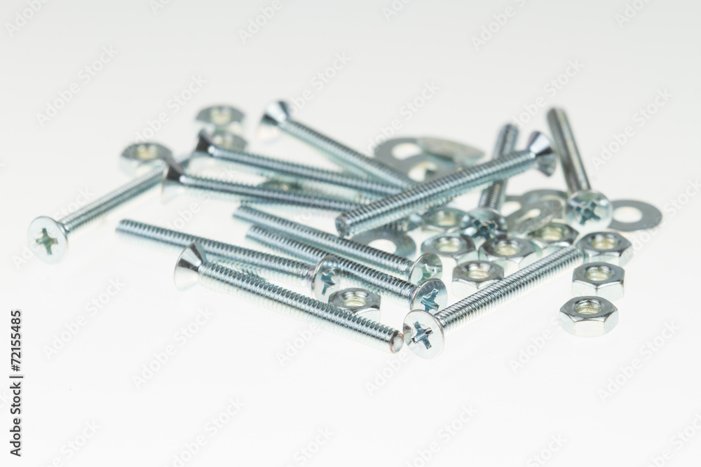 Screws, nuts, and bolts on isolated white background Screws, nuts, and bolts on isolated white background