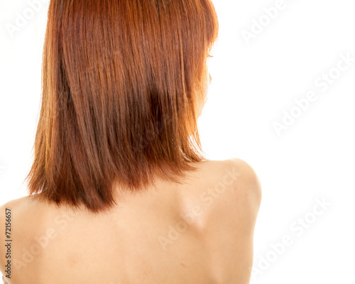 Asian woman looking back over bare shoulders