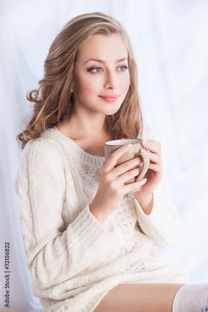 Woman enjoying coffee while relaxing at home Woman enjoying coffee while relaxing at home
