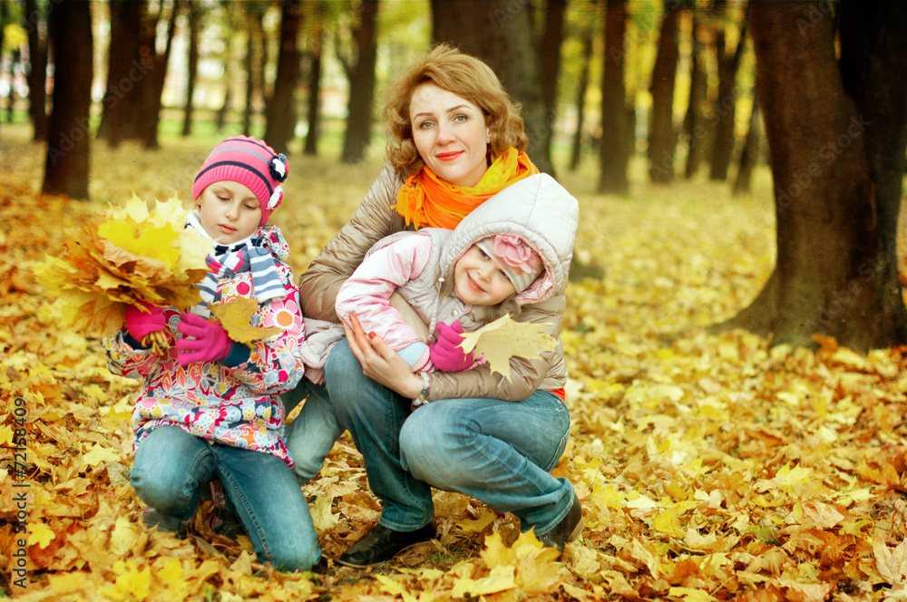 girls playing with her mother in autumn park girls playing with her mother in autumn park