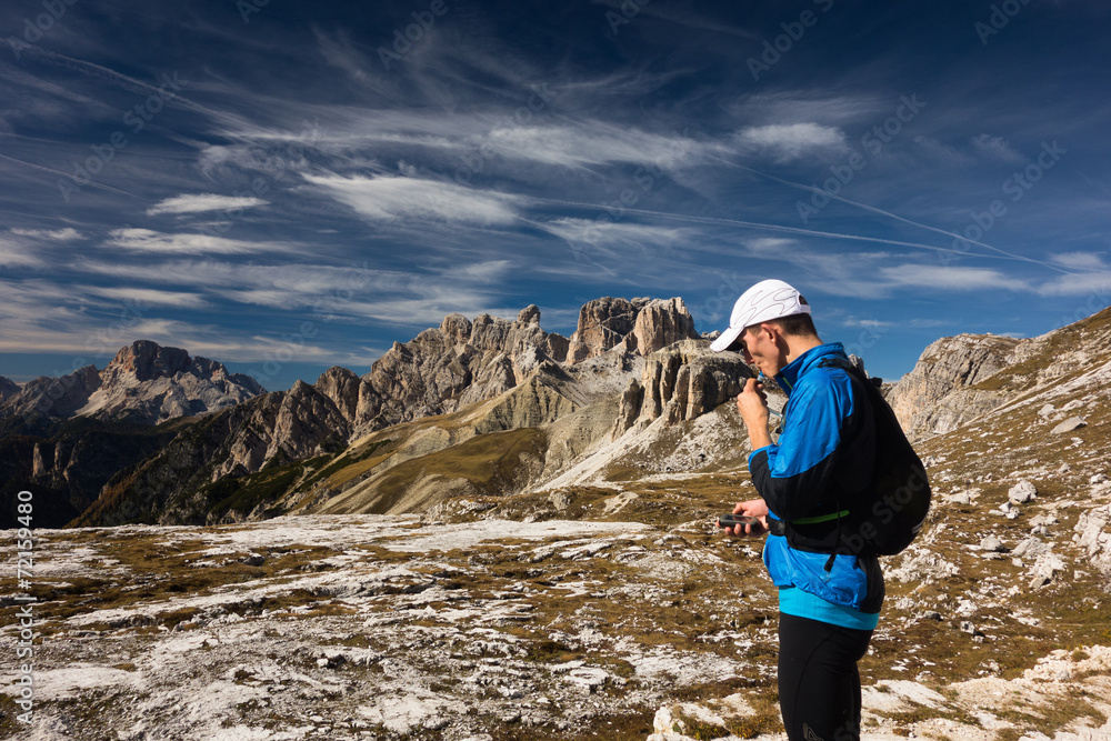 Tourist in Dolomites with GPS