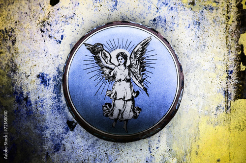 wonderful old tin can with angel motif on grunge background photo