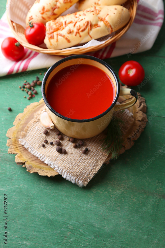 Homemade tomato juice in mug, spices and fresh tomatoes