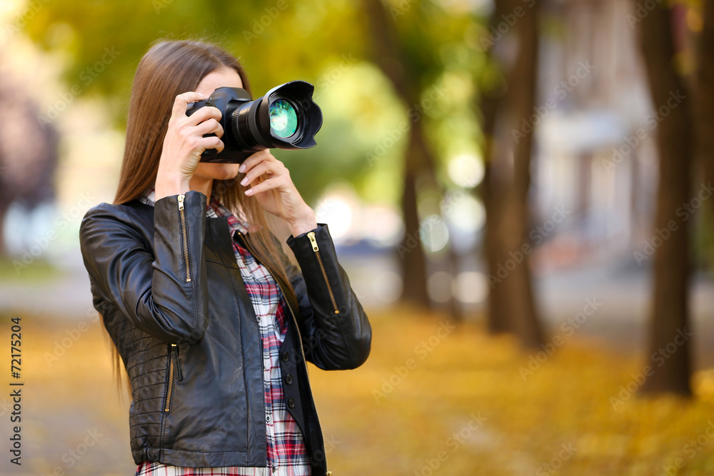 Beautiful young photography take photos outdoors in park