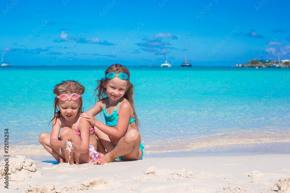 Adorable little girls in swimsuit and glasses for swimming at