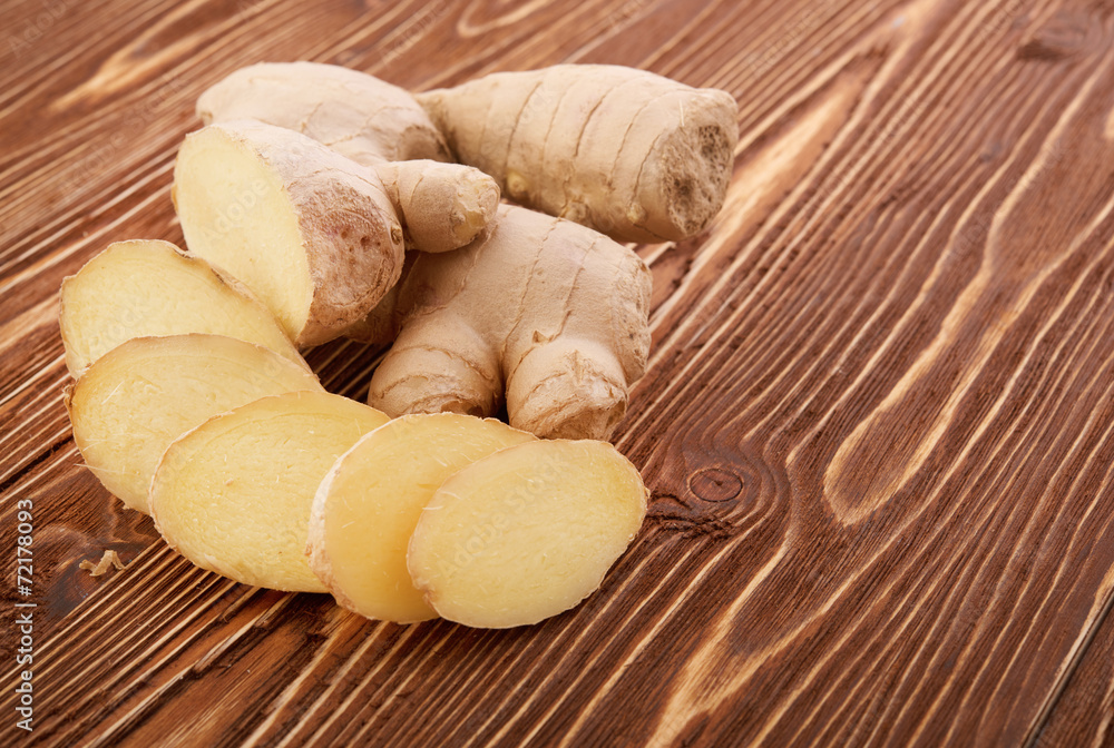 Ginger root sliced on wooden table Ginger root sliced on wooden table
